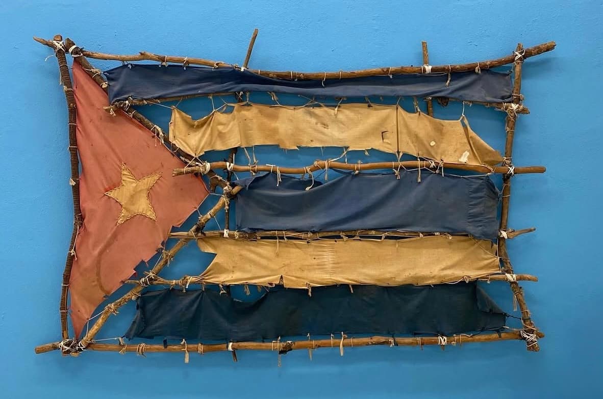 Heritage - 1989 - Sculpture: Wood, sheets from the National Art School, blue fabric from the artist’s mother’s dress, branches, wire, string, and earth.