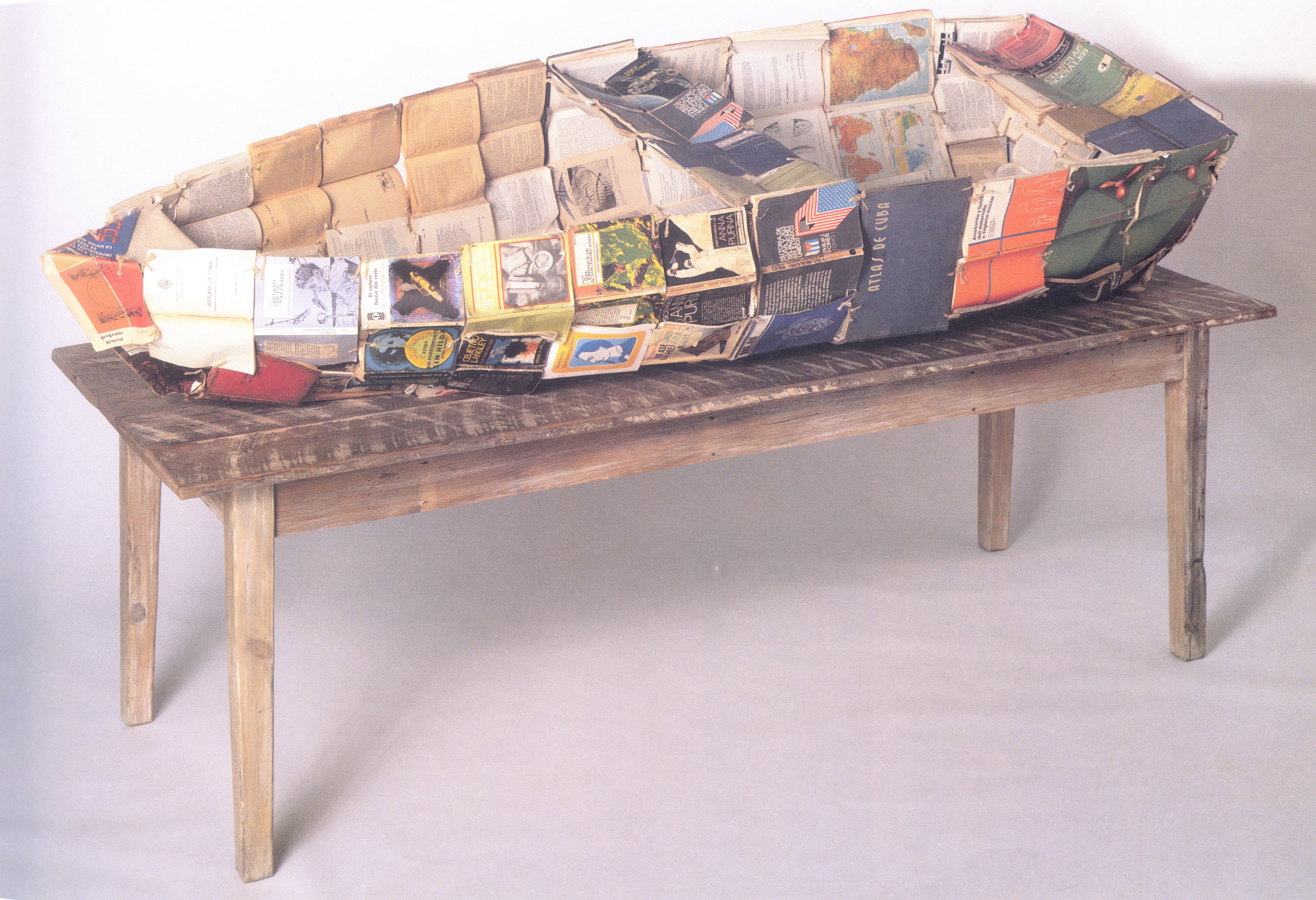 Selected Works - 1994 - Sculpture: Books, metal frame, wooden table, newspaper, and twine.